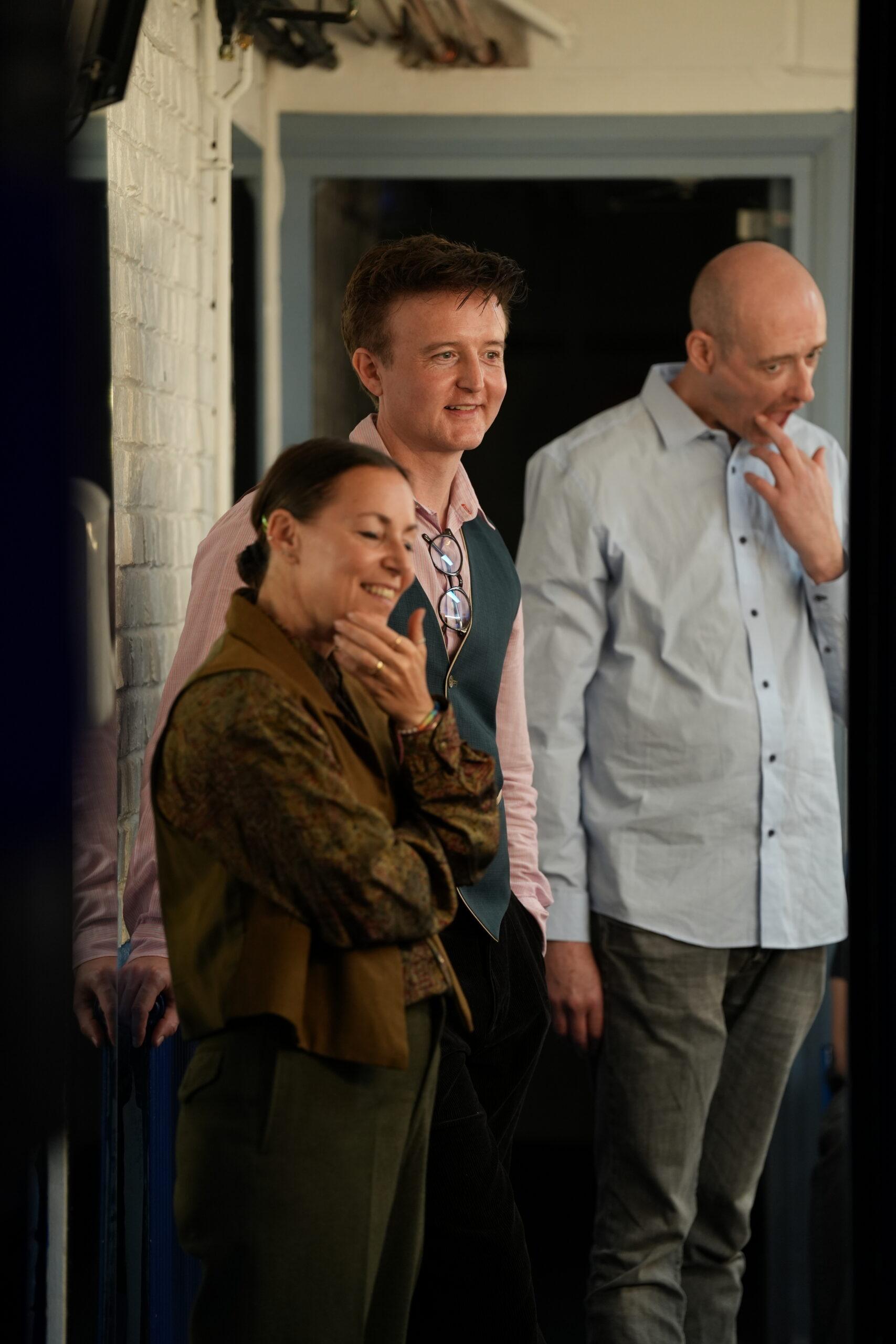 Three actors backstage in the Studio dressing room.